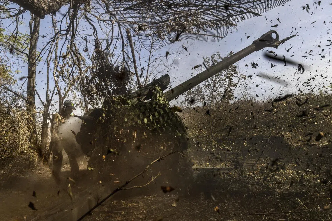 Ukrainian soldiers fire a Soviet-era  artillery gun at Russian positions on the outskirts of Bakhmut, in Ukraine's Donetsk region.