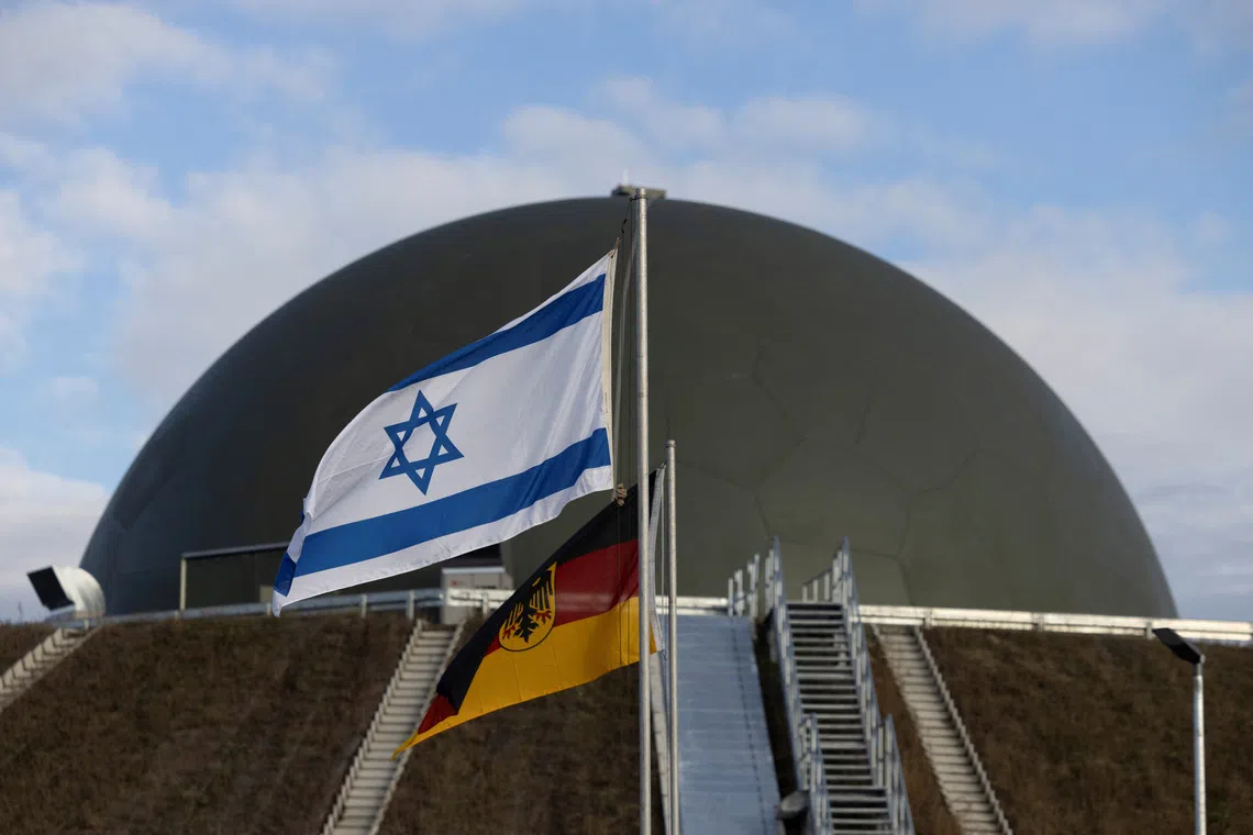 Flags flutter in front of a radom of the \"Arrow Weapon System for Germany\" pictured in Annaburg, Germany, December 3, 2025. REUTERS/Axel Schmidt