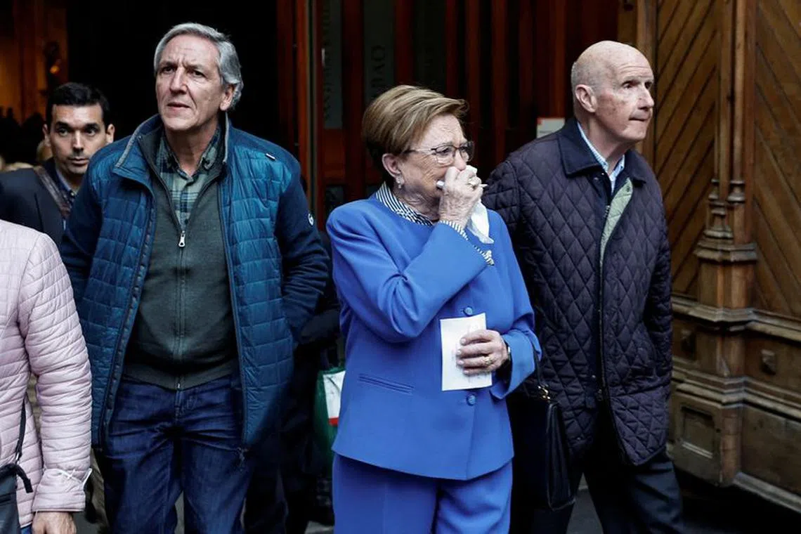 FILE PHOTO: A woman reacts while leaving a mass by the Bishop of Bilbao, Joseba Segura and priest Josu Lopez Villalba, a victim of sexual abuse, where forgiveness was asked for from victims of sexual abuse by the Catholic Church, in Bilbao, Spain, March 24, 2023. REUTERS/Vincent West/File Photo