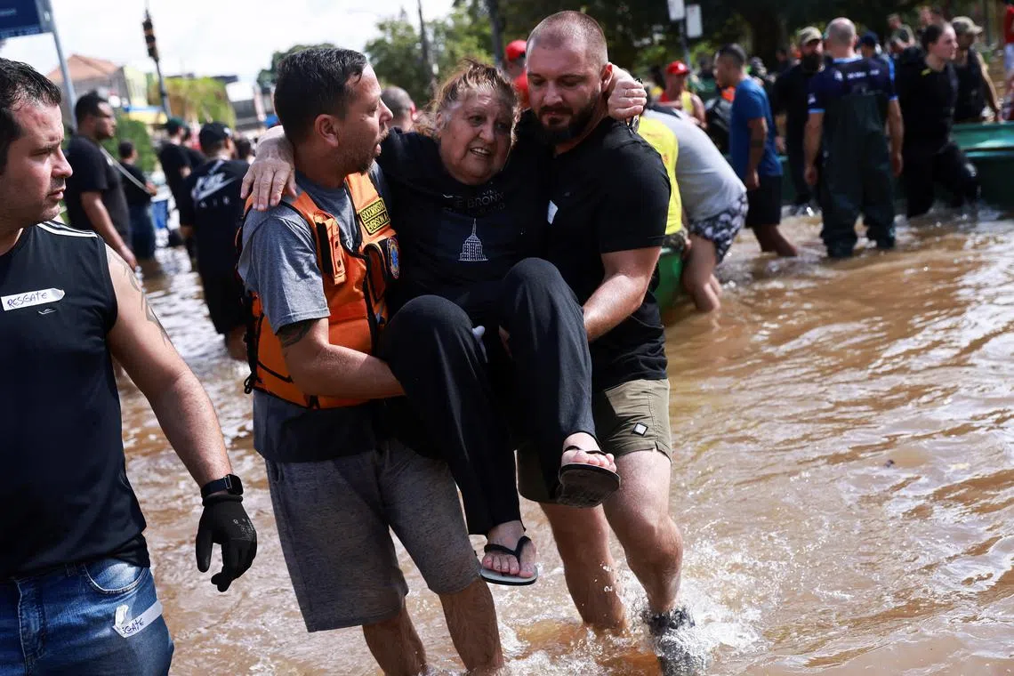 A woman is evacuated following the floods in Humaita, in Porto Alegre, on May 8, 2024.
