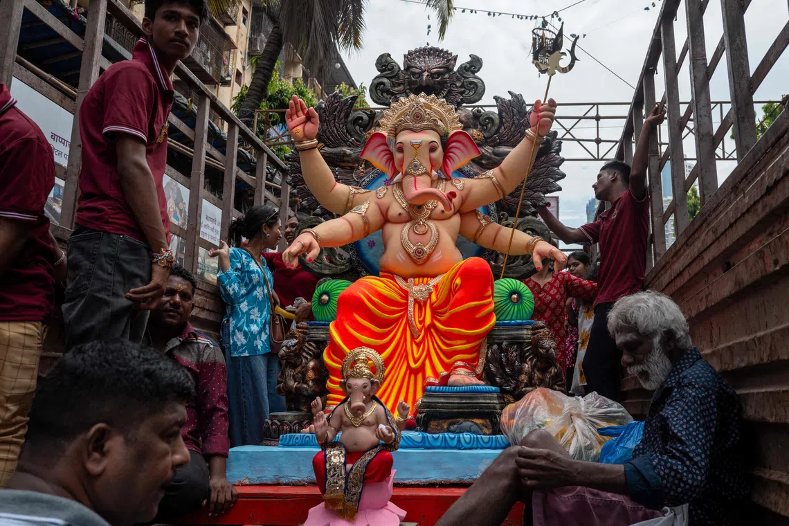 Devotees carry idols of Hindu deity Ganesha on the occasion of ‘Ganesh Chaturthi’ festival in Mumbai on September 14, 2026. (Photo by Punit PARANJPE / AFP)