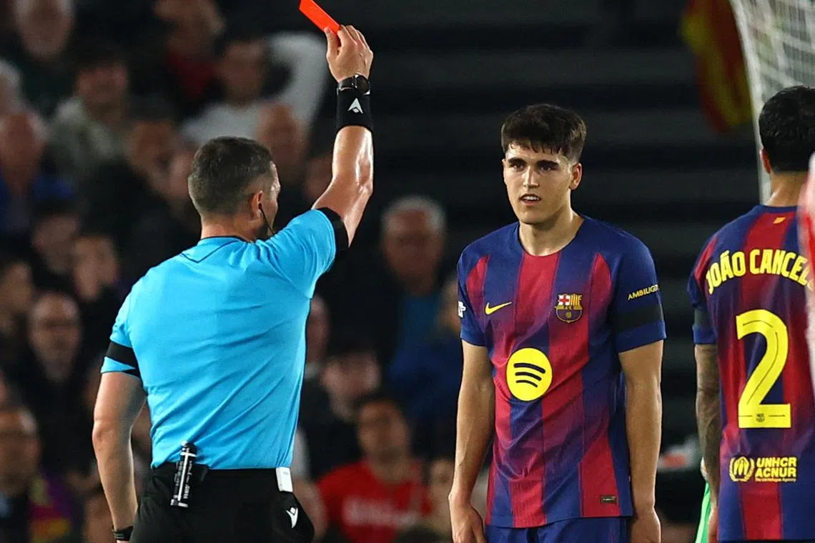 Soccer Football - UEFA Champions League - Quarter Final - First Leg - FC Barcelona v Atletico Madrid - Spotify Camp Nou, Barcelona, Spain - April 8, 2026 FC Barcelona's Pau Cubarsi is shown a red card by referee Istvan Kovacs REUTERS/Albert Gea