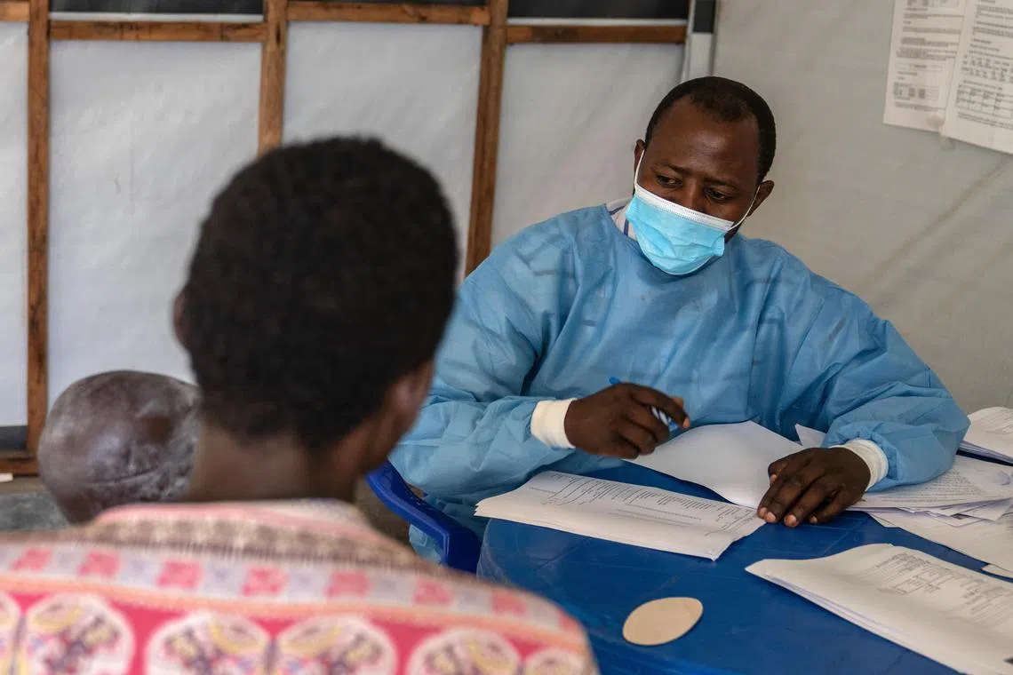 A medical staff attends to a child suffering from mpox at the Munigi Health Centre in the Democratic Republic of the Congo on Aug 19.