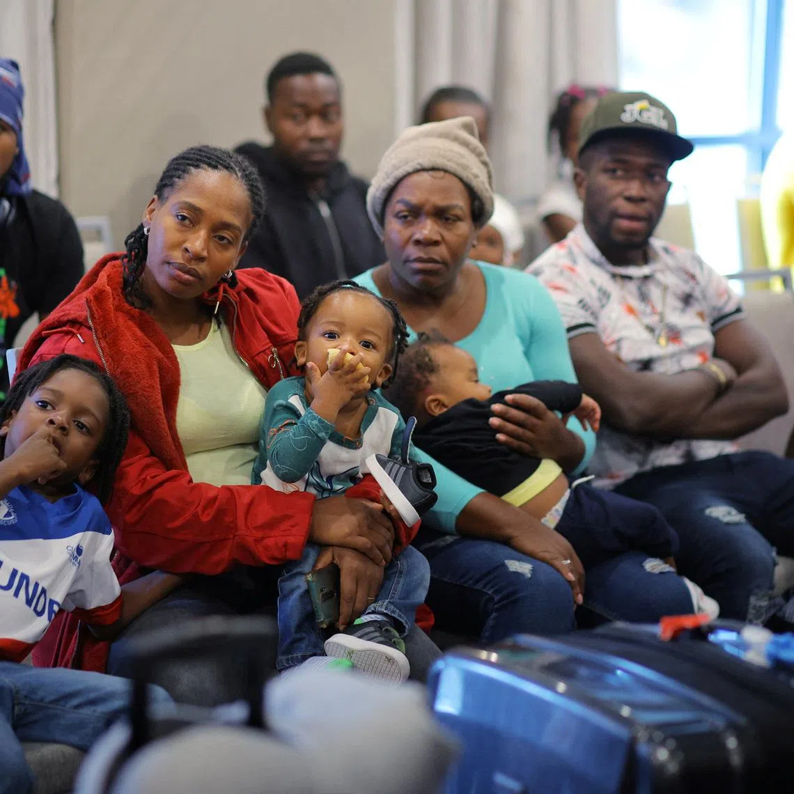 Immigrants from Haiti who recently arrived in Boston from other parts of the United States listen to instructions from representatives of La Colaborativa, a non-profit community services organization based in Chelsea, as they arrive at temporary housing in a hotel in Everett, Massachusetts, U.S., July 10, 2023.     REUTERS/Brian Snyder/File Photo