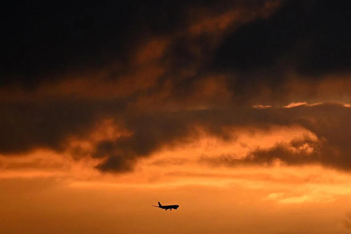An aircraft approaching the Frankfurt Airport for landing during sunrise in Frankfurt, Germany on Feb 20, 2024, during a strike action by ground crews, services staff and security personnel. 
