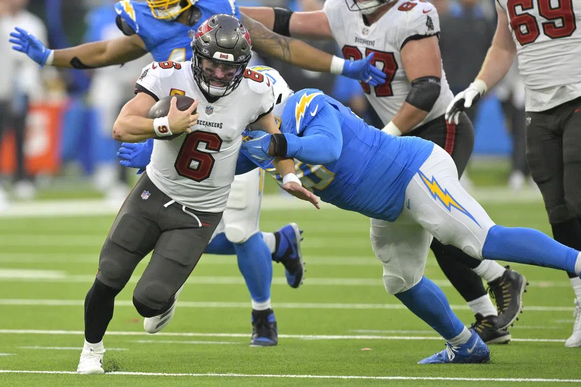 Dec 15, 2024; Inglewood, California, USA; Tampa Bay Buccaneers quarterback Baker Mayfield (6) runs the ball ipast Los Angeles Chargers defensive tackle Teair Tart (90) in the second half at SoFi Stadium. Jayne Kamin-Oncea-Imagn Images/File Photo