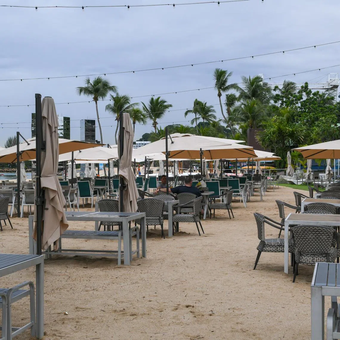 Few patrons can be seen at Ola Beach Club on Siloso Beach on June 30, 2024.