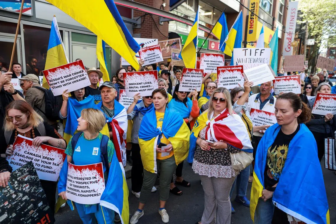 Protesters gather outside the Toronto International Film Festival (TIFF) screening of 'Russians at War', a documentary about Russian troops fighting in Ukraine, in Toronto, Ontario, Canada September 10, 2024. REUTERS/Carlos Osorio