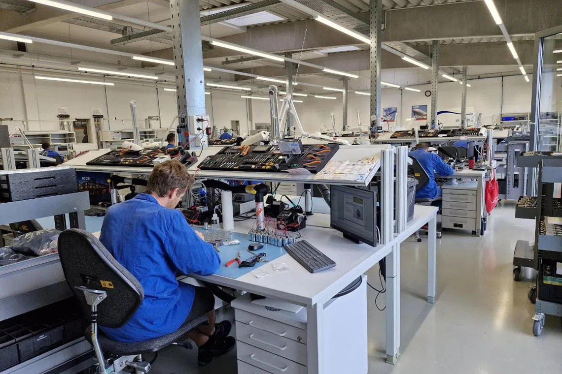 sagermany - SAM GmbH: Staff assembling electronic parts at the Singapore Aerospace Manufacturing production facility at Bad Tolz, Bavaria, Germany. 

credit: ST PHOTO: SUE-ANN TAN