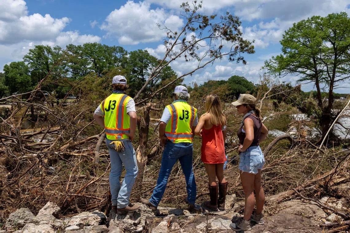 FILE PHOTO: People take part in the search and rescue operation looking for missing people by the Guadalupe River, in Hunt, Texas, U.S. July 9, 2025. REUTERS/Umit Bektas/File Photo