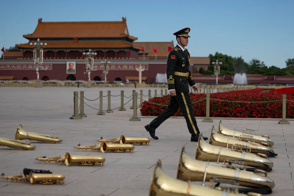 epaselect epa13271934 A member of the music band of the People’s Liberation Army walks past musical instruments on the ground ahead of a ceremony at the Monument to the People's Heroes on Martyrs' Day, a celebration honoring deceased national heroes, in Tiananmen Square in Beijing, China, 30 September 2026. Martyrs' Day is held on the eve of the National Day of the People's Republic of China, which marks its 77th Anniversary this year. EPA/ANDRES MARTINEZ CASARES