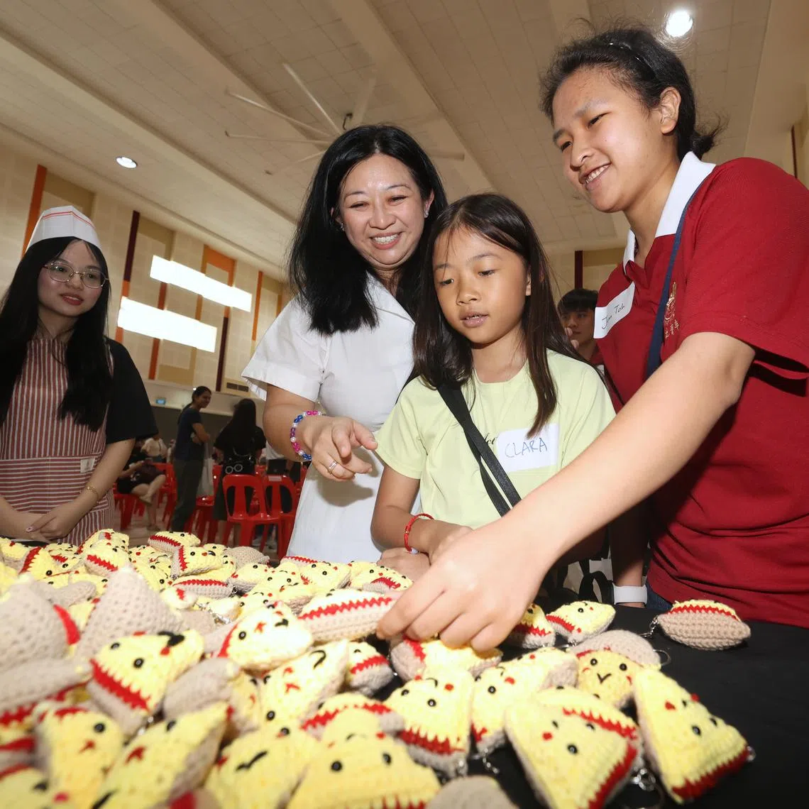 Pasir-Ris Punggol GRC MP Yeo Wan Ling (second from left) giving out crocheted "positivity pizzas" to youths on March 23.