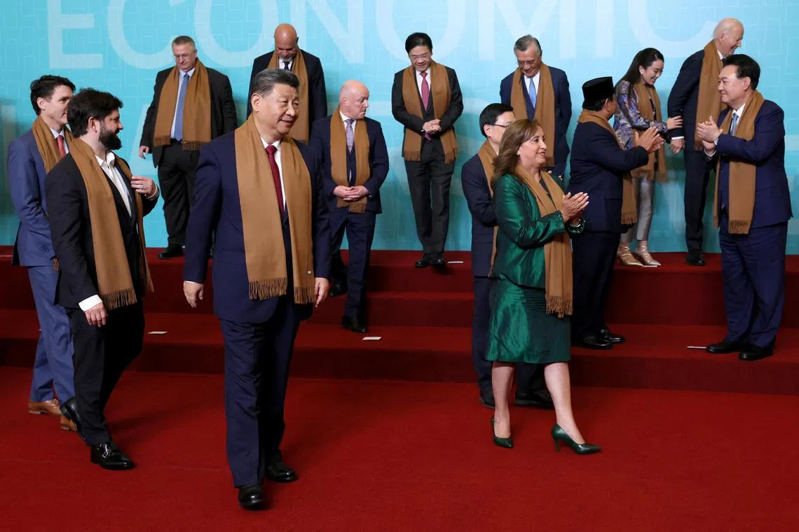 PM Lawrence Wong (back row, centre) with Chinese President Xi Jinping (left) and other world leaders at the Apec summit in Lima, Peru, on Nov 16. 