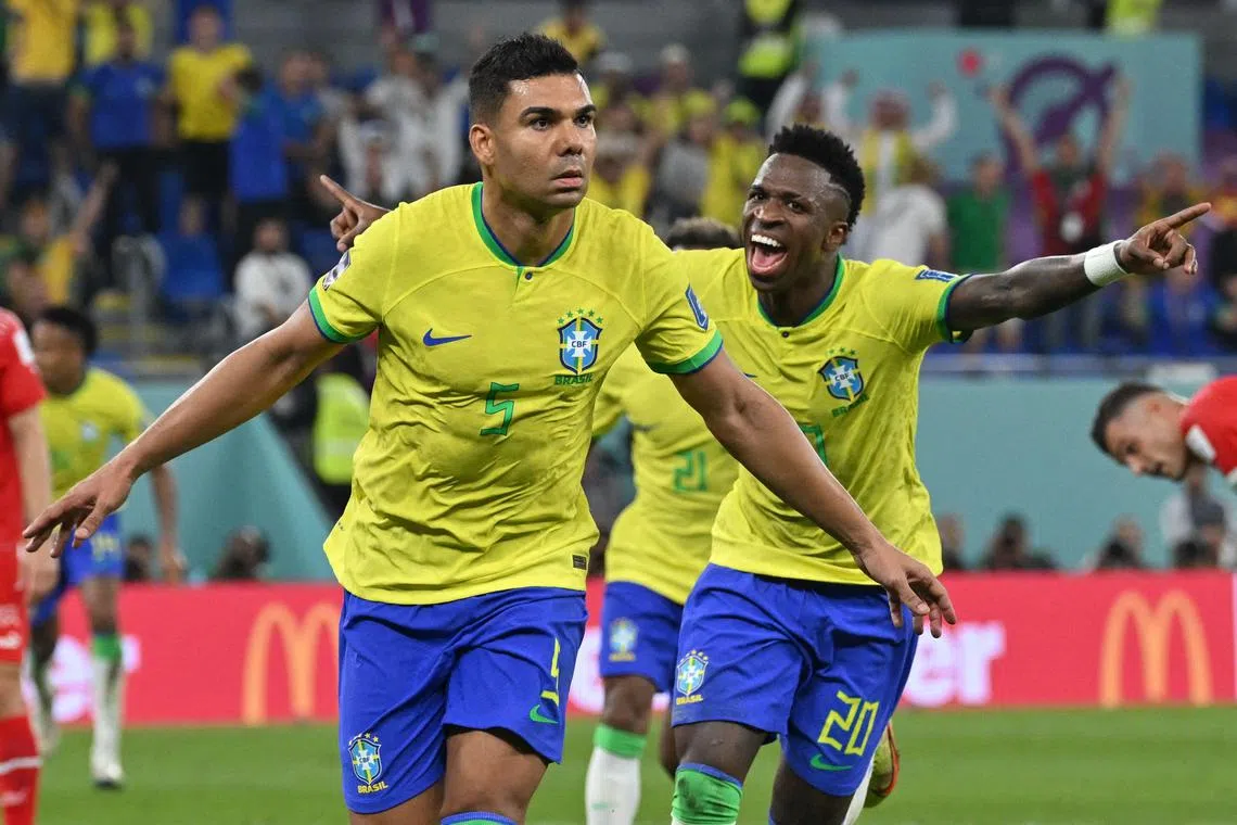 Brazil's midfielder Casemiro celebrates with forward Vinicius Junior after he scored in the 1-0 World Cup win over Switzerland.