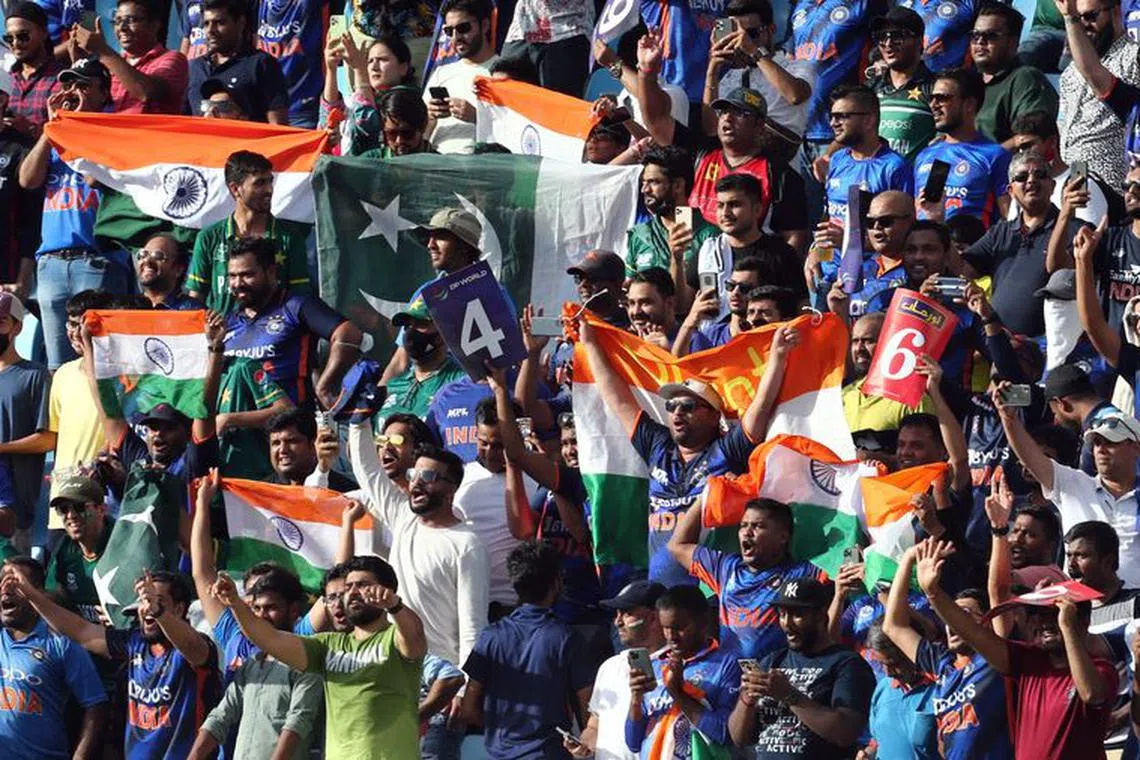 FILE PHOTO: Cricket - Asian Cup - India v Pakistan - Dubai International Stadium, Dubai, United Arab Emirates - August 28, 2022 Fans are pictured with flags inside the stadium before the match REUTERS/Satish Kumar/File Photo