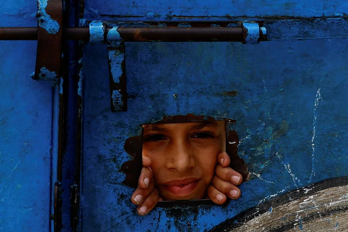 A Palestinian looks through the doorway of a UNRWA school in the Maghazi area of central Gaza May May 20, 2026. REUTERS/Mahmoud Issa TPX IMAGES OF THE DAY