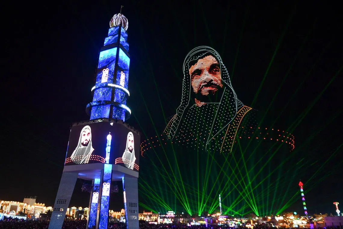 TOPSHOT - An image depicting Sheikh Zayed bin Sultan al-Nahyan, founder and first president of the United Arab Emirates, is created by drones at the New Year's Eve show during the Sheikh Zayed Heritage Festival in Abu Dhabi on January 1, 2025. (Photo by Ryan LIM / AFP)