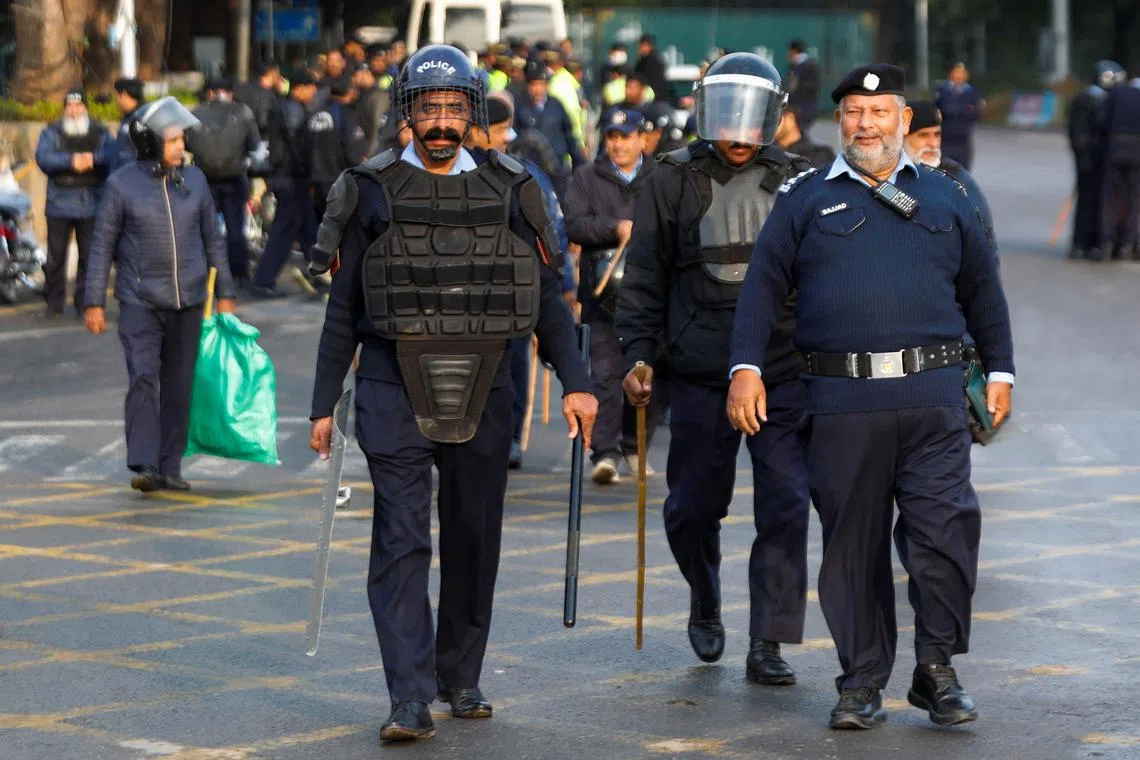 Police officers walk to guard a road to prevent an anti-government rally by supporters of the former Pakistani Prime Minister Imran Khan's party Pakistan Tehreek-e-Insaf (PTI) in Islamabad, Pakistan, November 24, 2024. REUTERS/Salahuddin