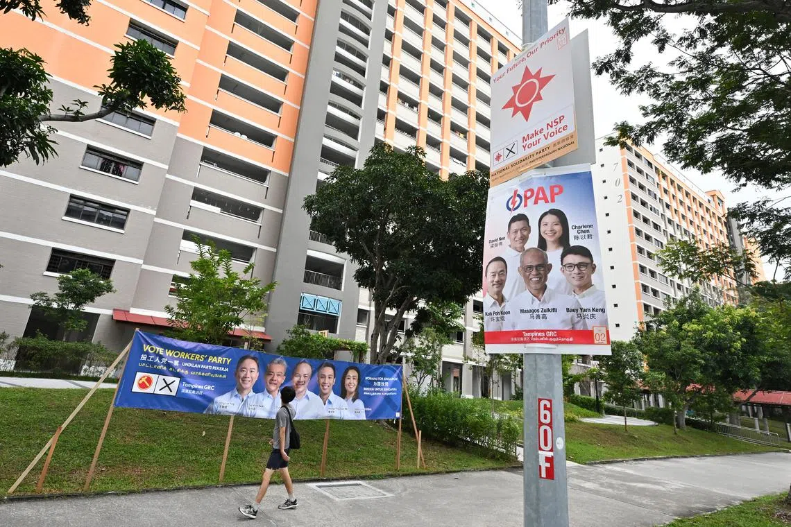 Posters of Tampines GRC candidates from Workers' Party, People's Action Party and National Solidarity Party seen near Block 701 Tampines Street 71 on April 26, 2025.
