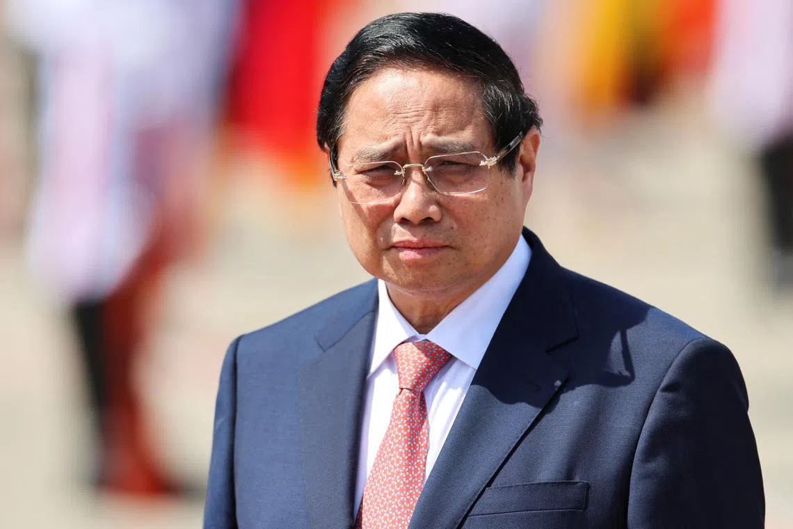 FILE PHOTO: Vietnamese Prime Minister Pham Minh Chinh waits for Chinese President Xi Jinping to arrive before his departure, following his visit to Hanoi at Noi Bai International Airport in Vietnam, April 15, 2025. REUTERS/Athit Perawongmetha/Pool