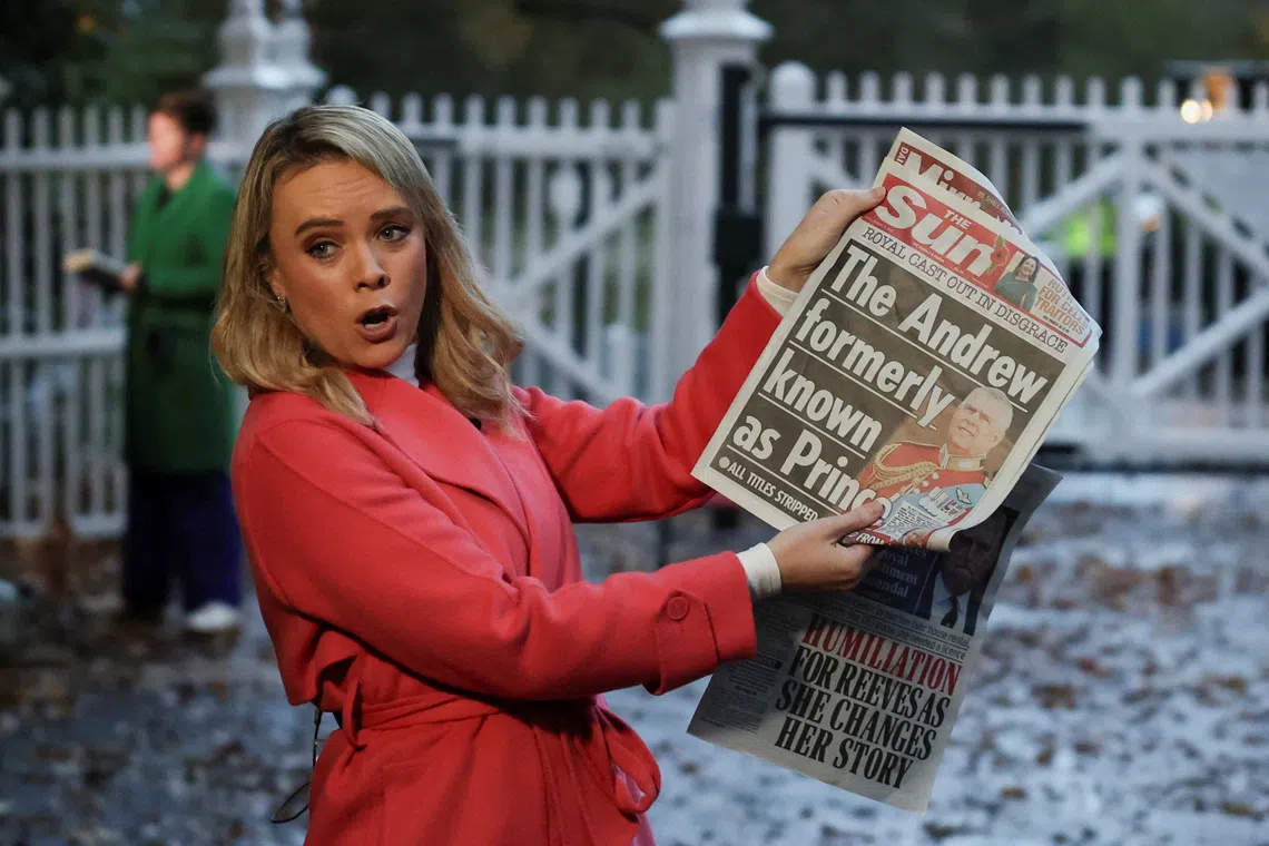 A member of the media shows the front page of a newspaper outside the entrance to the Royal Lodge, a large property on the estate surrounding Windsor Castle, where Andrew, the younger brother of Britain's King Charles lives, in Windsor, Britain, October 31, 2025. Britain's King Charles has stripped his younger brother Andrew of his title of prince and forced him out of his Windsor home, Buckingham Palace said on Thursday, seeking to distance the royals from him over his links to the Jeffrey Epstein scandal. REUTERS/Suzanne Plunkett