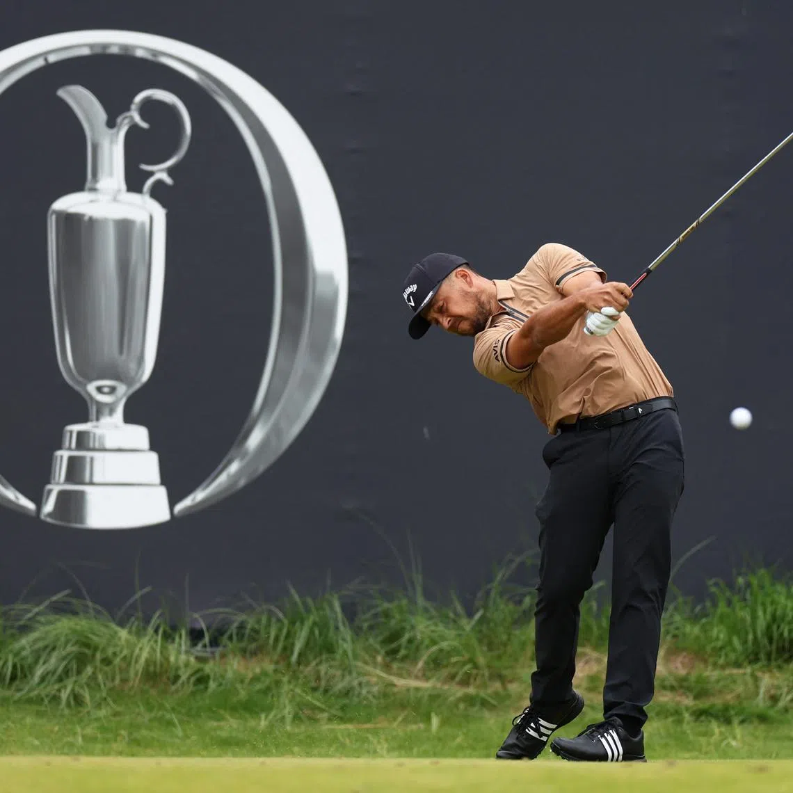 Golf - The 153rd Open Championship - Royal Portrush Golf Club, Portrush, Northern Ireland, Britain - July 19, 2025 Xander Schauffele of the U.S. hits his tee shot on the 1st hole during the third round REUTERS/Russell Cheyne
