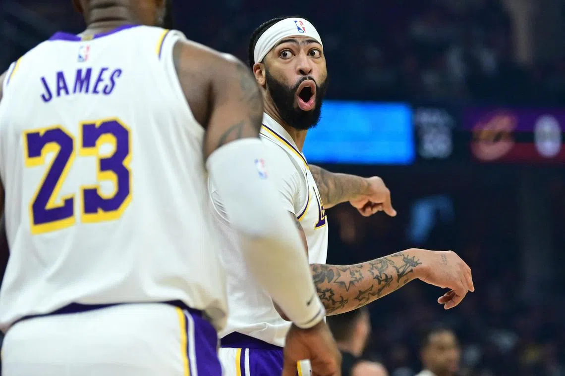Los Angeles Lakers forward Anthony Davis reacting after a play with forward LeBron James during the first half of Nov 25's 121-115 victory over the Cavaliers at Rocket Mortgage FieldHouse in Cleveland.