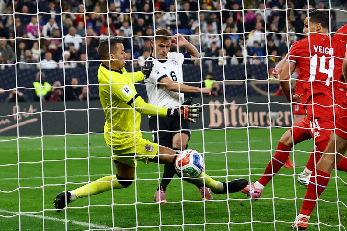 Soccer Football - FIFA World Cup - UEFA Qualifiers - Group A - Germany v Luxembourg - Rhein-Neckar-Arena, Sinsheim, Germany - October 10, 2025 Germany's Joshua Kimmich scores their fourth goal past Luxembourg's Anthony Moris REUTERS/Kai Pfaffenbach