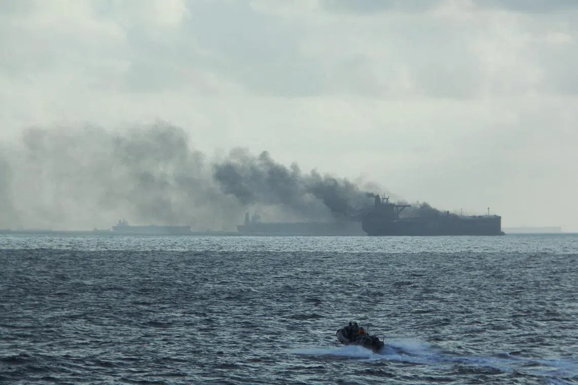 The RSS Supreme's rigid-hulled inflatable boat in the vicinity of burning vessels following a fire on two oil tankers near the Singaporean island of Pedra Branca.