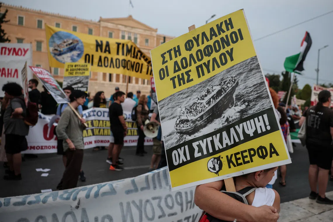 A protester carries a placard reading \"no to cover-up\" as activists, survivors and other protesters gather to mark the second anniversary of one of the Mediterranean's worst shipwrecks in 2023 off Greece's southwestern town of Pylos, in Athens, Greece, June 21, 2025. REUTERS/Louisa Gouliamaki