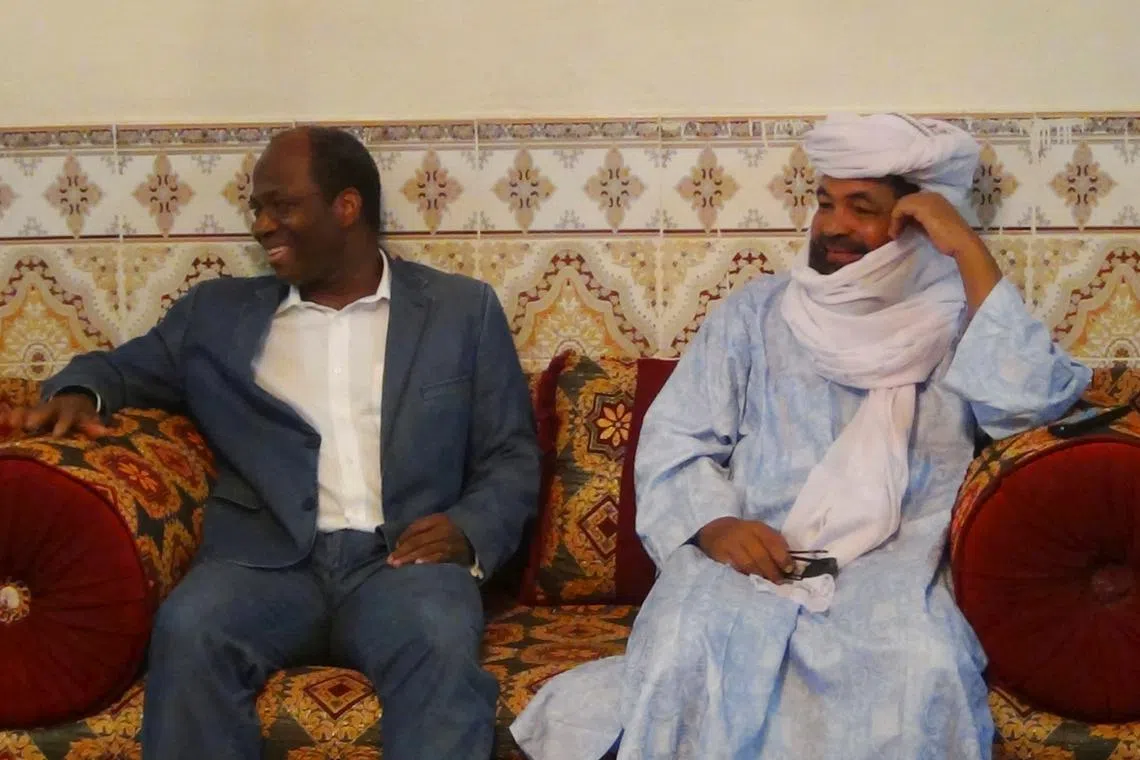 FILE PHOTO: Iyad Ag Ghaly (R), the alleged leader of Ansar Dine, an al Qaeda-linked Islamist group in northern Mali, meets with Burkina Faso's then foreign minister, Djibril Bassole, in Kidal, northern Mali, August 7, 2012. REUTERS/Stringer/File Photo