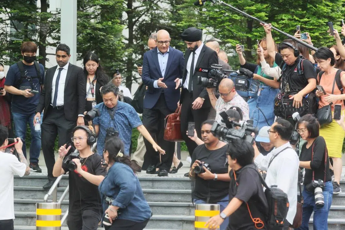 Former Transport Minister S. Iswaran, surrounded by press, leaving the State Court on Jan 18.
