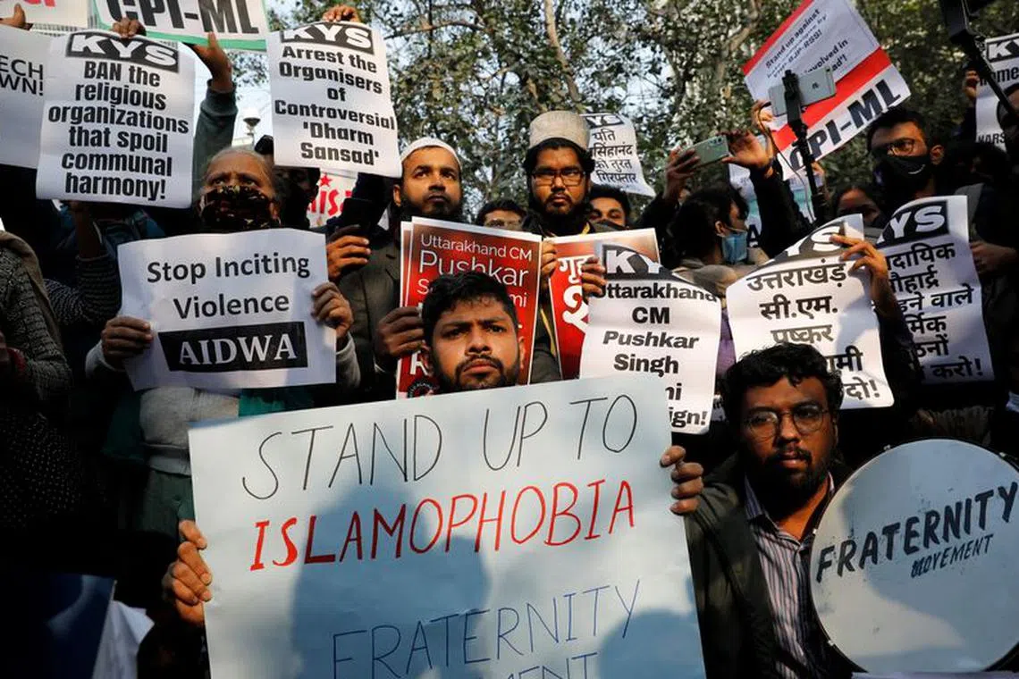 Demonstrators hold placards during a protest against what they say is hate speech against Muslims by Hindu leaders, in New Delhi, India, December 27, 2021. REUTERS/Adnan Abidi/File Photo