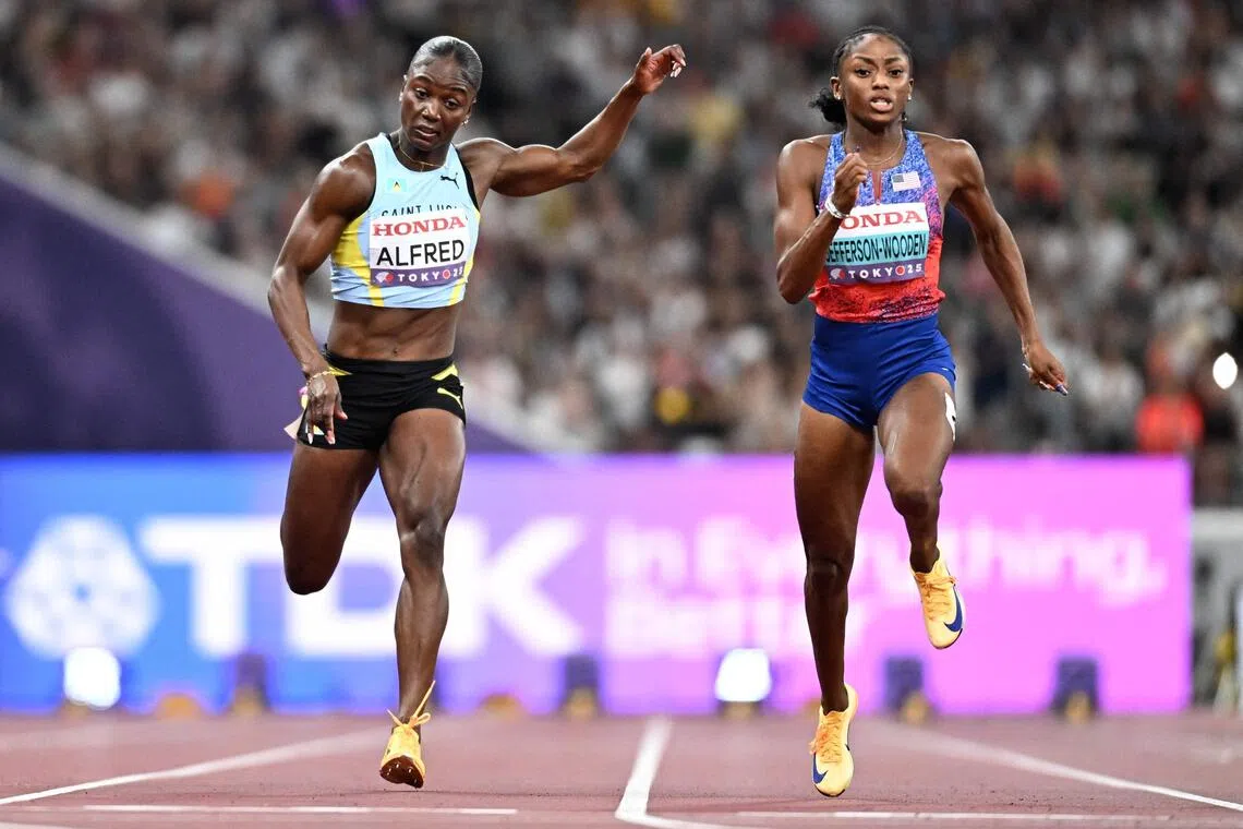 The United States' Melissa Jefferson-Wooden (right) crosses the finish line to win the women's 100m final during the World Athletics Championships in Tokyo on Sept 14, 2025. Saint Lucia's Olympic champion (left) Julien Alfred finished third.