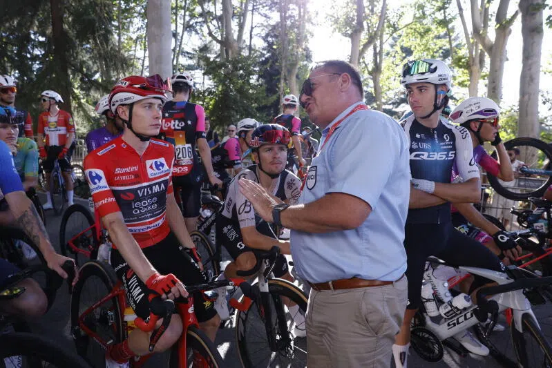 A UCI commissioner informs the Overall leader, Danish rider Jonas Vingegaard (left) of Visma team, and the rest of the riders about the end of the 21st and last stage of La Vuelta a Espana cycling race.