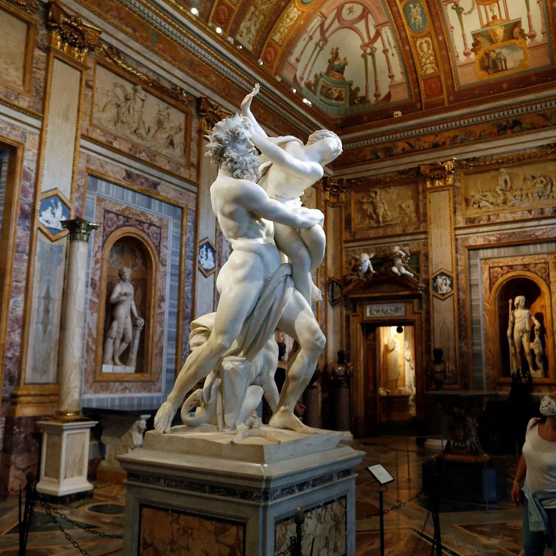 FILE PHOTO: A visitor looks at a statue inside Galleria Borghese, in Rome, Italy, May 22, 2020. REUTERS/Yara Nardi/File Photo