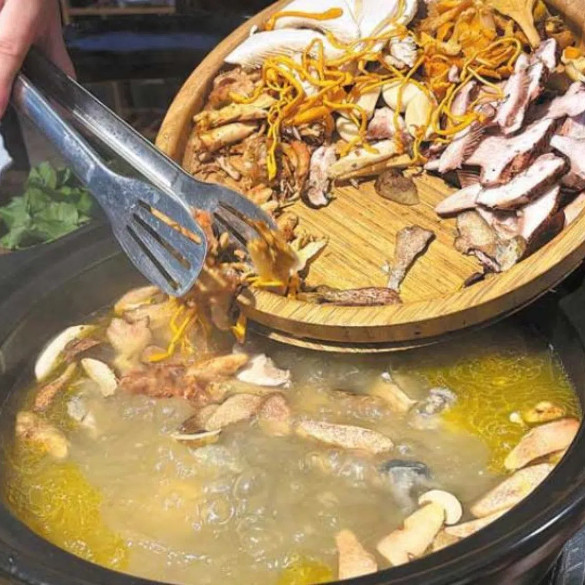 A wild mushroom and chicken soup hotpot being served in Kunming, in China’s Yunnan province.