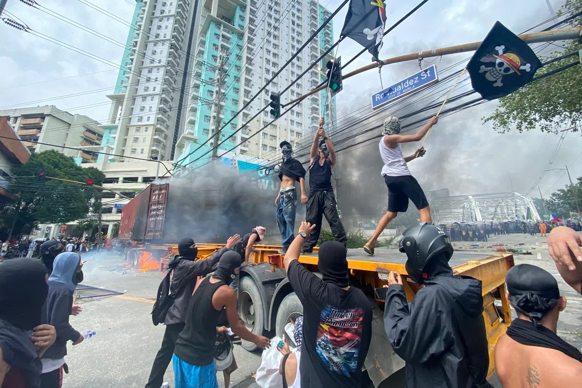 Protesters scuffle with anti-riot police during a protest rally in Manila, Philippines, on Sept 21.