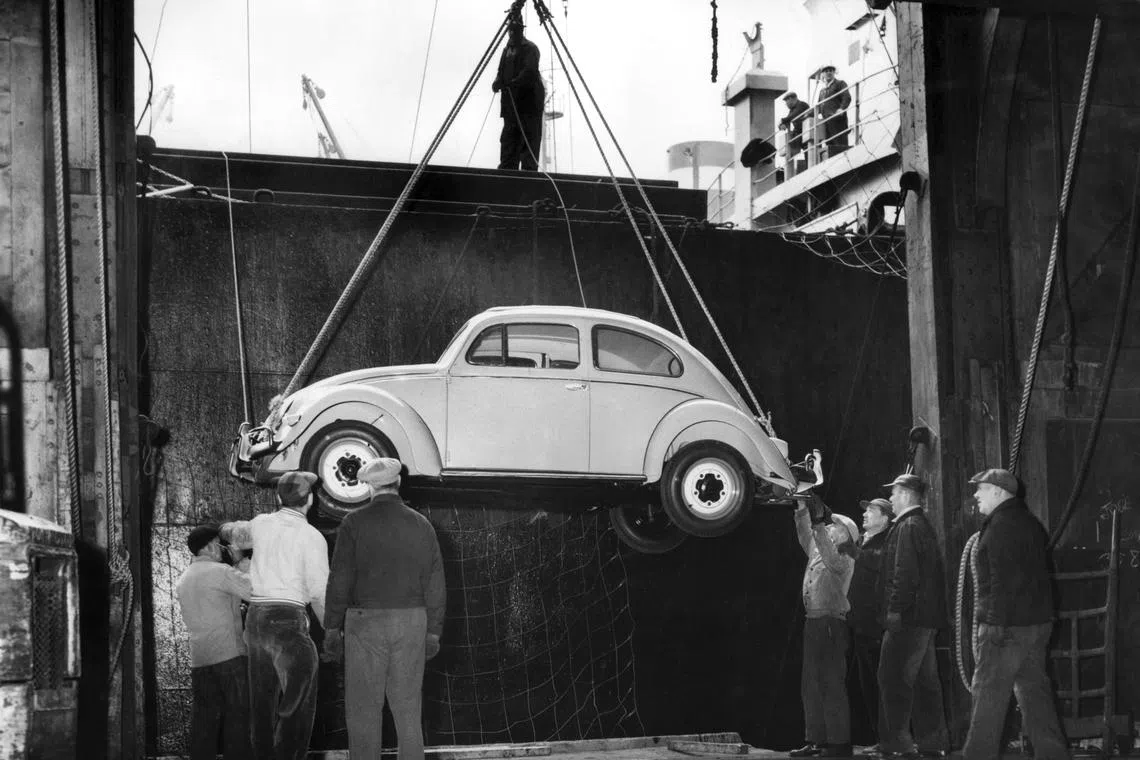 A Volkswagen Beetle arrives at Pier 61 of the US Lines in Manhattan on Nov 26, 1956. 