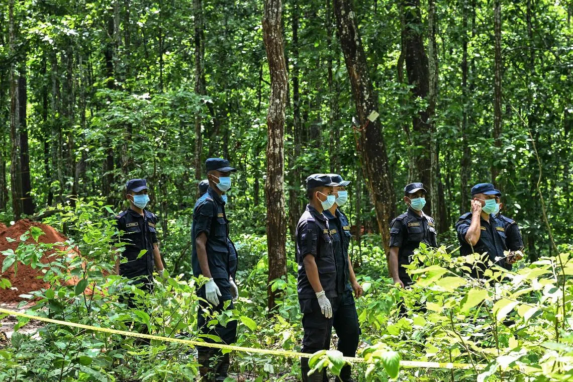 Police personnel prepare for the mass burial of victims of deadly flash floods at Devghat in Nepal’s Chitwan district.