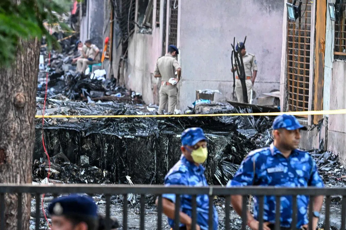 Police standing guard at the site after Air India Flight A171 crashed in a residential area near the airport in Ahmedabad, on June 13, 2025. 