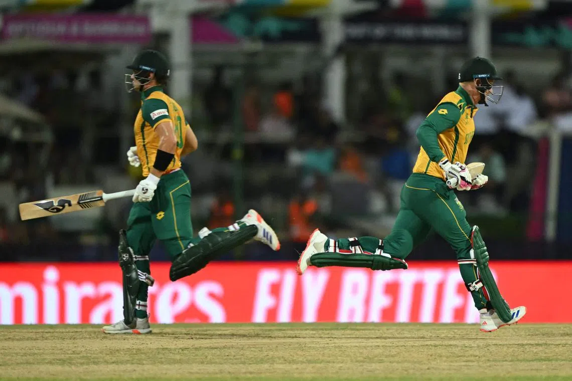 South Africa's Tristan Stubbs (left) and Heinrich Klaasen running between the wickets in the ICC Twenty20 World Cup Super Eight cricket match against West Indies at Sir Vivian Richards Stadium in North Sound, Antigua and Barbuda on June 23, 2024. South Africa won by three wickets under the DLS method.