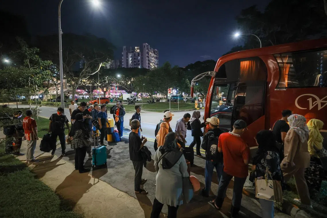 About 90 Singapore football fans getting ready to board two buses heading to Malaysia to watch the Causeway Derby at the Bukit Jalil Stadium the following day.