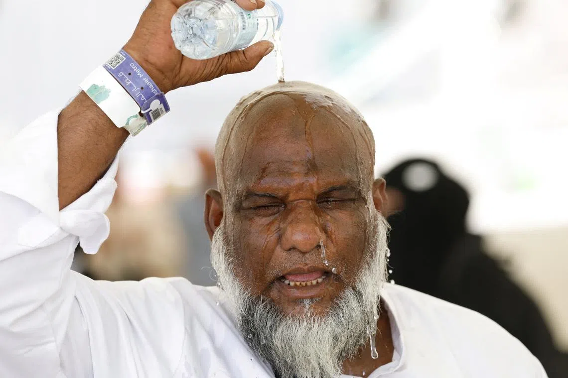 A Muslim pilgrim pours water on his head to cool down from the heat, as he takes part in the annual haj pilgrimage in Mina, Saudi Arabia, June 17, 2024. REUTERS/Mohammed Torokman