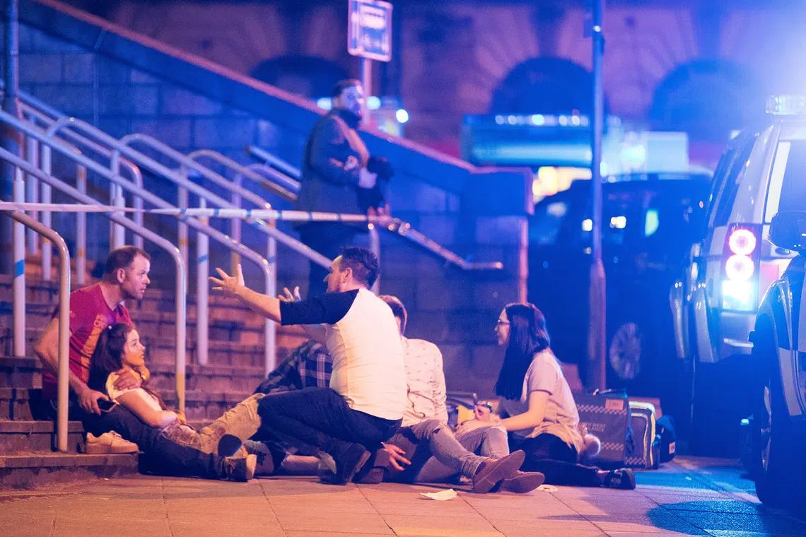 Wounded concert-goers after a suicide bomb blast at the end of a concert by US singer Ariana Grande at Manchester Arena on May 22, 2017.