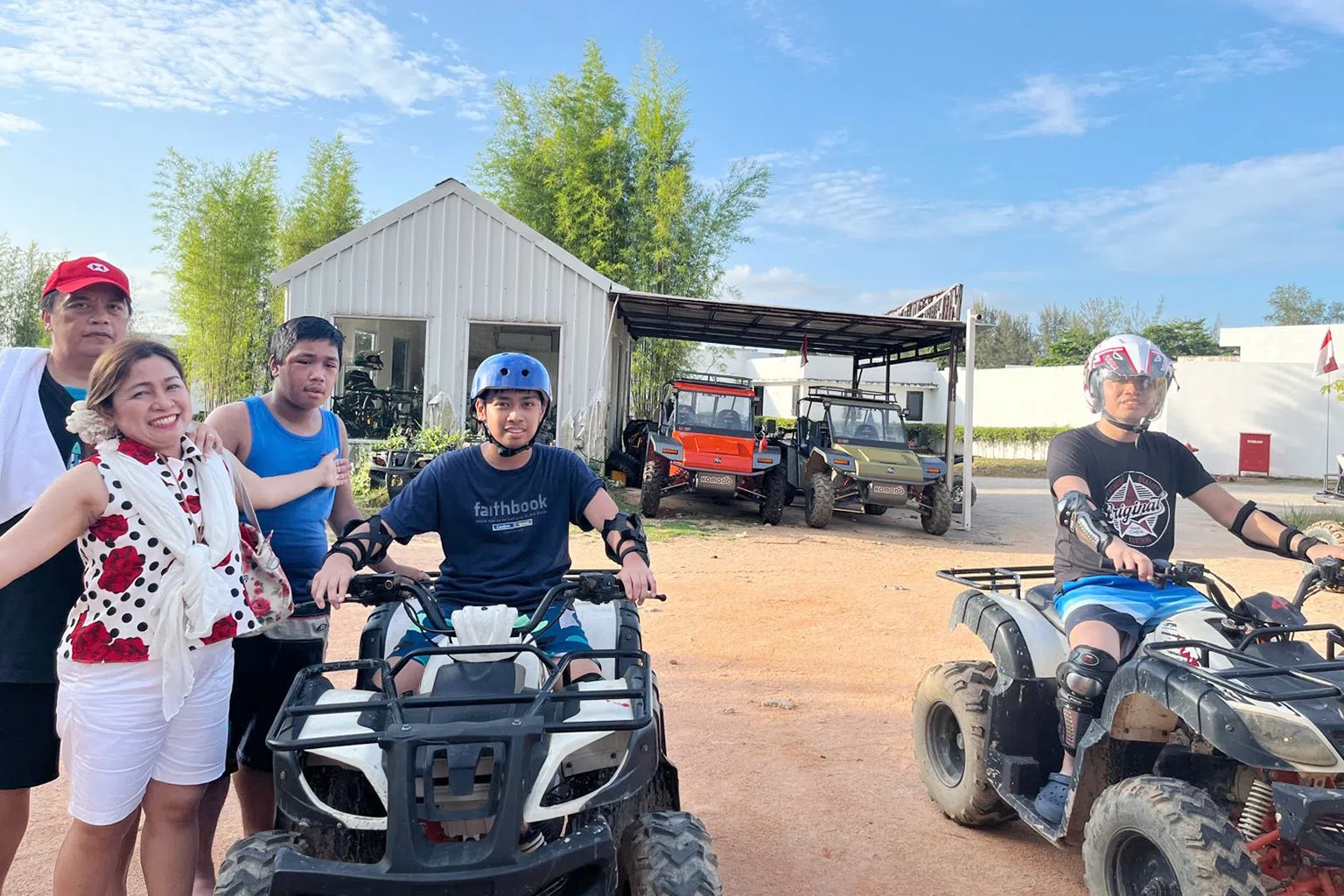 Mabel and Joseph Soliven with their three sons riding ATVs
