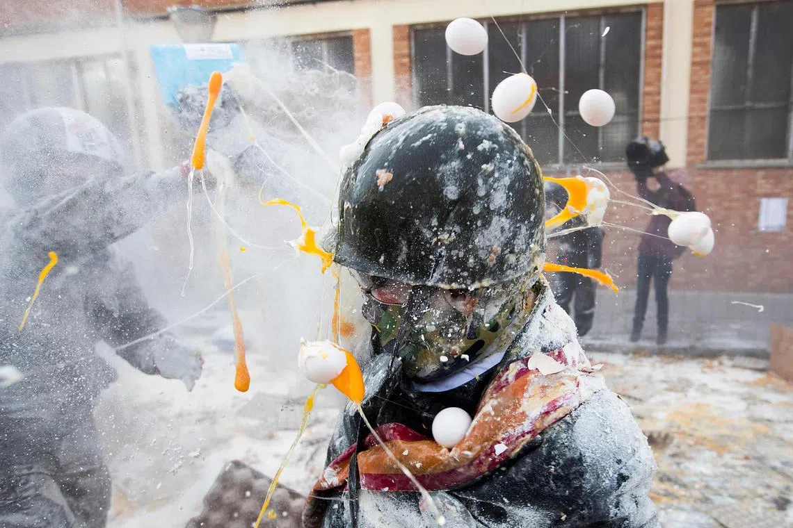 Revellers dressed in mock military garb taking part in the "Els Enfarinats" battle in the southeastern Spanish town of Ibi on Dec 28, 2023.