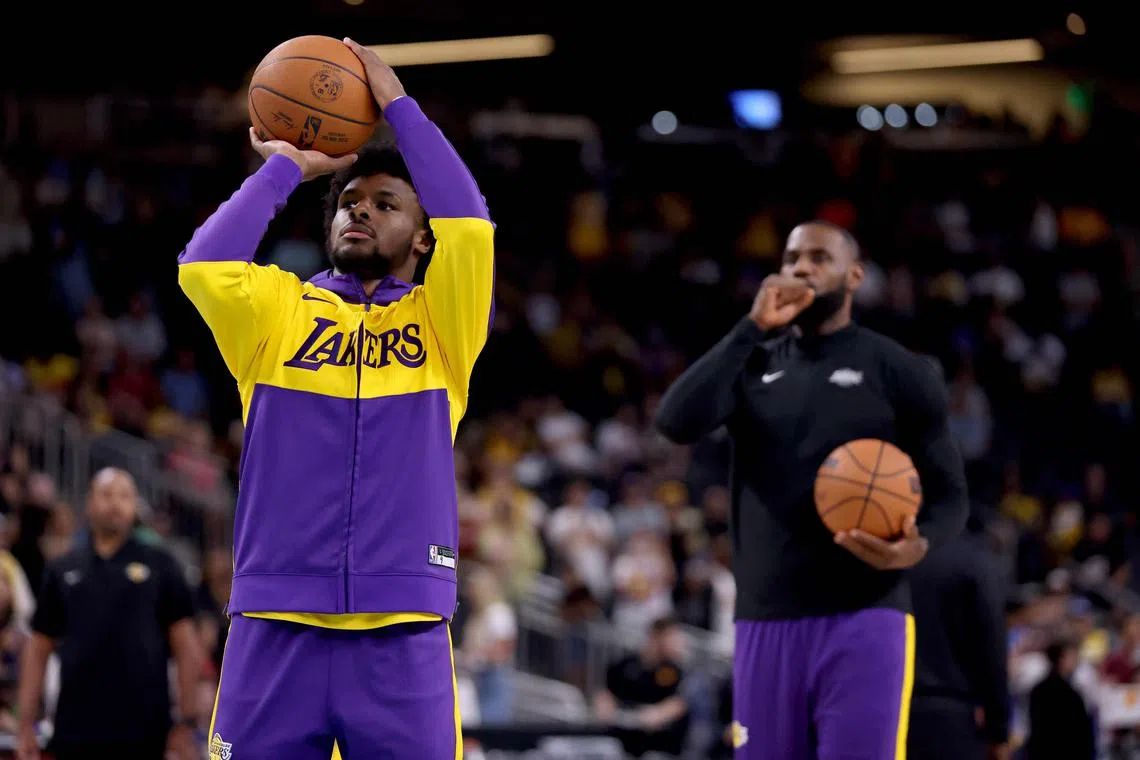 Bronny James and LeBron James of the Los Angeles Lakers warm up prior to the game against the Phoenix Suns at Acrisure Arena.