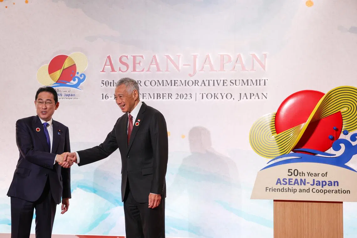 Japan's Prime Minister Fumio Kishida greeting Singapore's Prime Minister Lee Hsien Loong at the Asean-Japan Commemorative Summit Meeting in Tokyo on Dec 17.