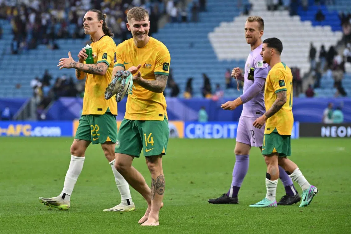Australia's players leave the pitch after their match against Uzbekistan.